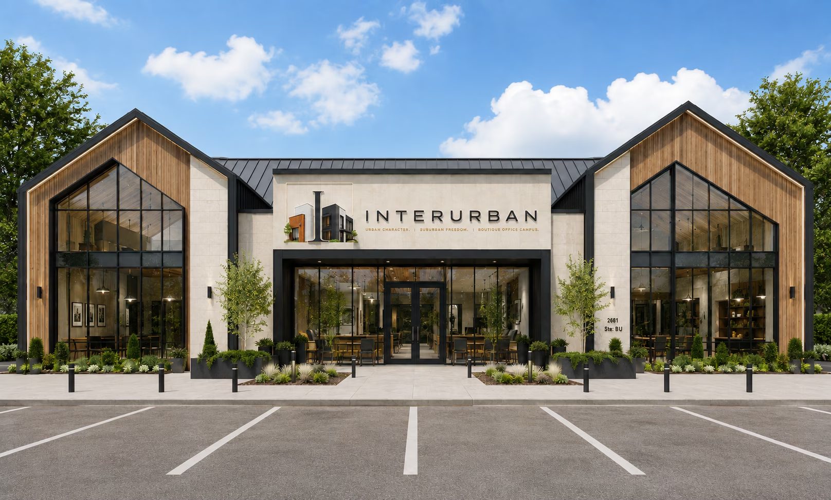 The Interurban office campus in West Plano — a two-story building with twin cedar-clad gables, limestone center bay and blackened steel storefront glazing, with surface parking at the door